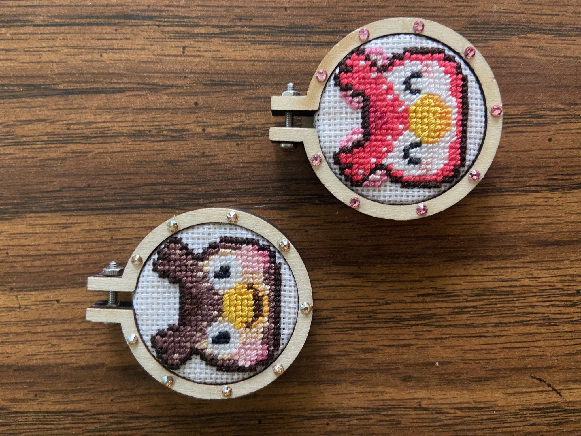 Two small cross stitch hoops featuring Blathers and Celeste from Animal Crossing.